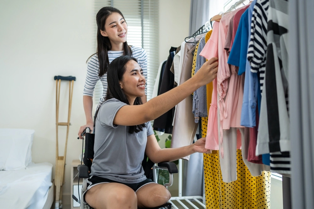 woman helping a disabled friend pick clothes
