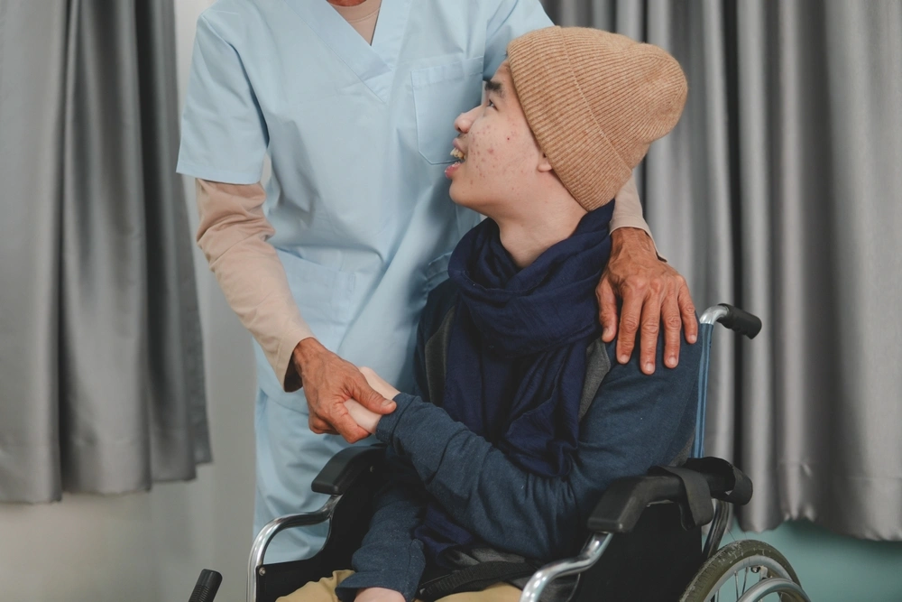 Nurse taking care of a boy on wheel chair